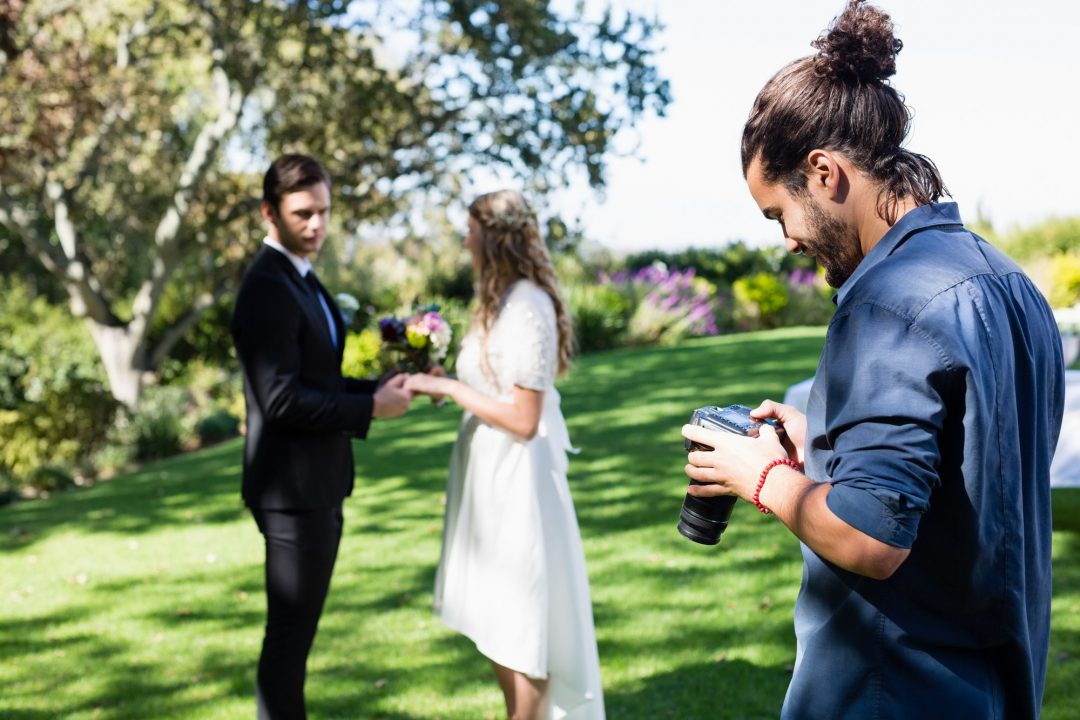 photographer-reviewing-photographs-on-digital-camera.jpg